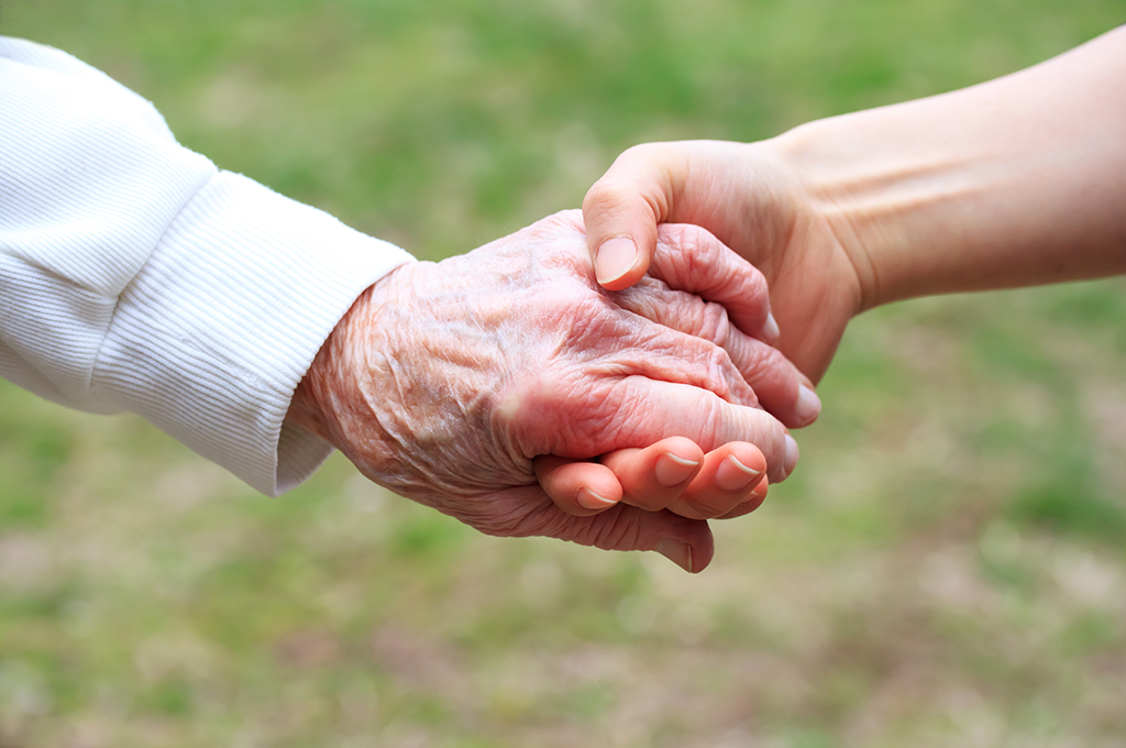 photo of two hands clasping, one older and one younger