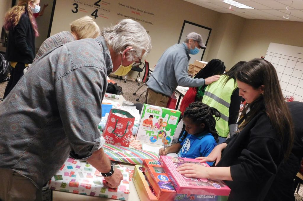 volunteers wrapping presents