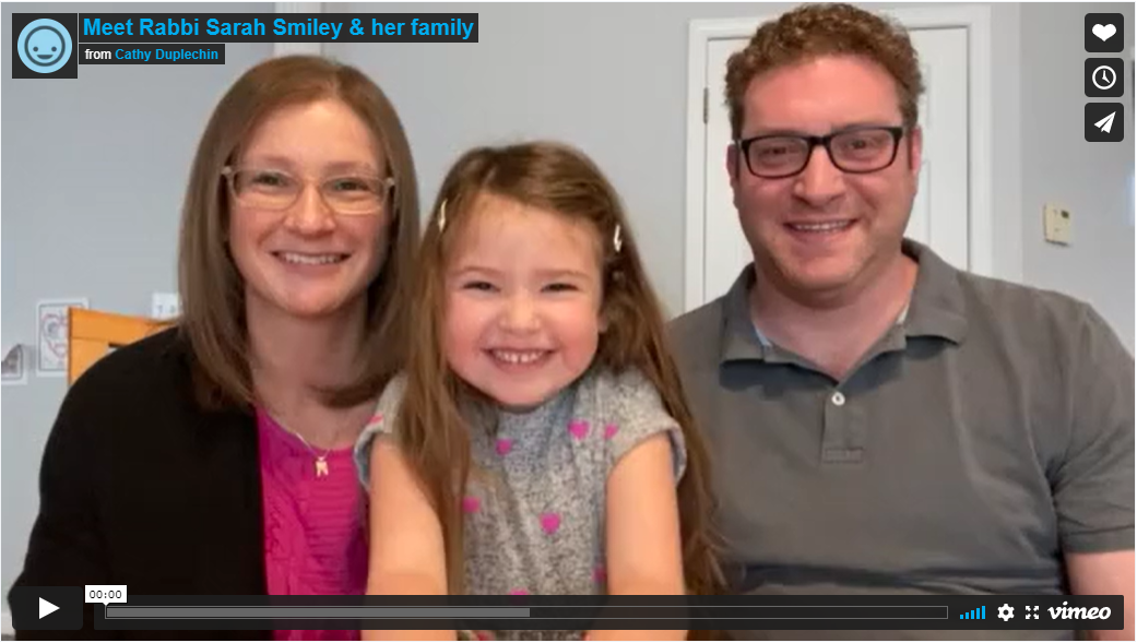 This is a screenshot of a video that shows Rabbi Sarah Smiley and Rabbi Josh Leighton with their young daughter in the middle of them.