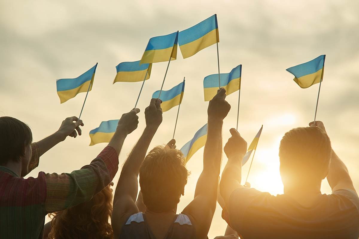 Crowd with ukrainian flags in the evening